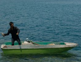 A fisherman about to throw a fish bomb in Kudat waters.